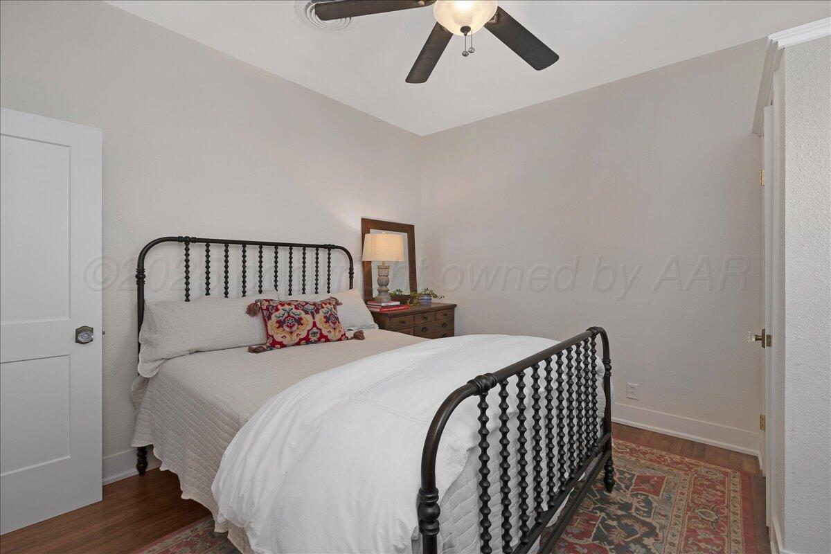 2007 6th Avenue Canyon, TX 79015 - Photo 19 of 33 a bedroom with a bed and wooden floor