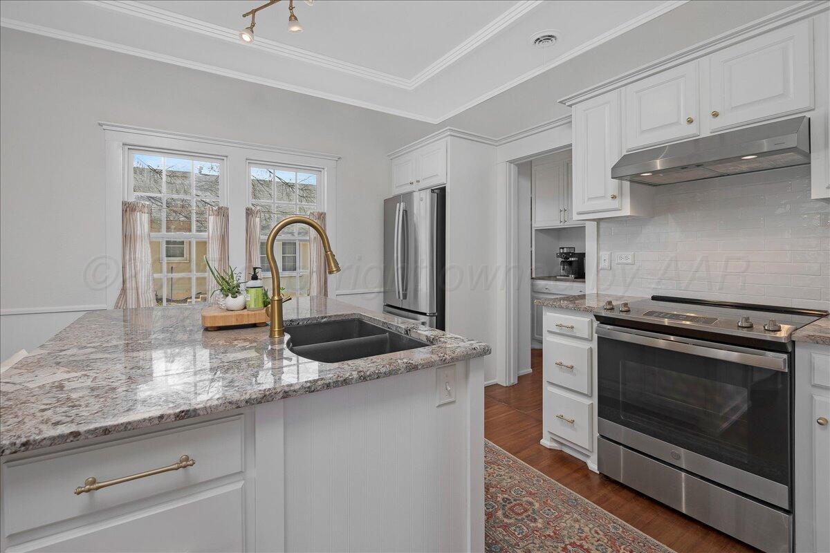 2007 6th Avenue Canyon, TX 79015 - Photo 9 of 33 a kitchen with stainless steel appliances granite countertop a stove a sink and a microwave
