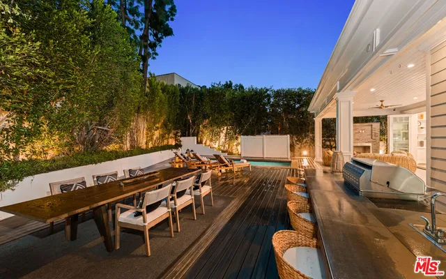 a living room with furniture a chandelier and a dining table
