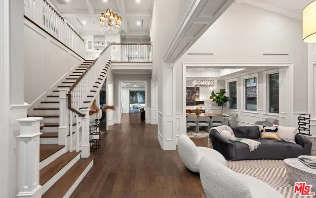 an open kitchen with granite countertop a stove a sink a counter space and wooden floor