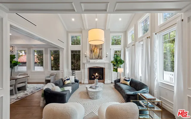 a kitchen with granite countertop a table chairs sink and wooden floor
