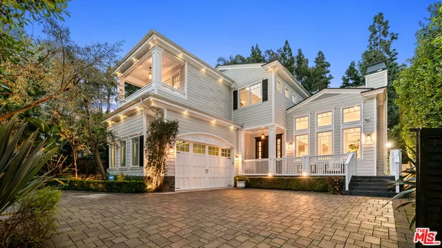 a view of a house with pool and chairs