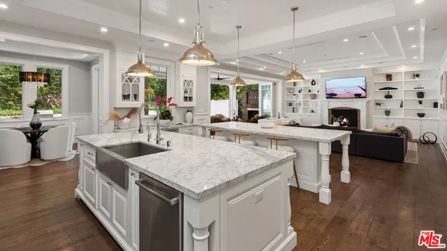 a spacious bedroom with bed and wooden floor