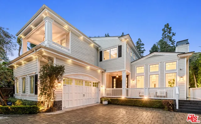 a front view of a house with outdoor seating