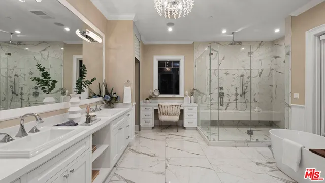 a view of a white building among the street with palm trees