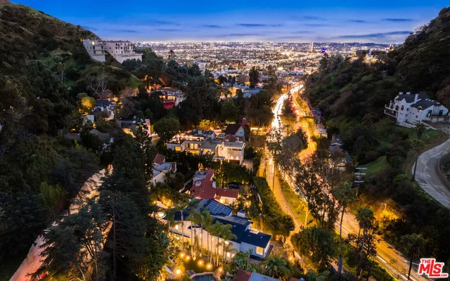 a living room with furniture chandelier and a fireplace