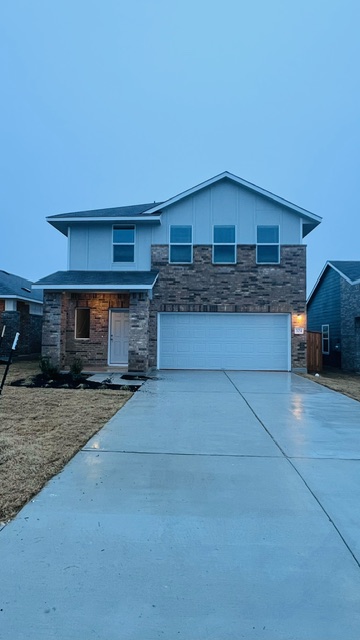 304 The Bad Way Jarrell, TX 76537 - Photo 4 of 26 a front view of a house with yard and parking