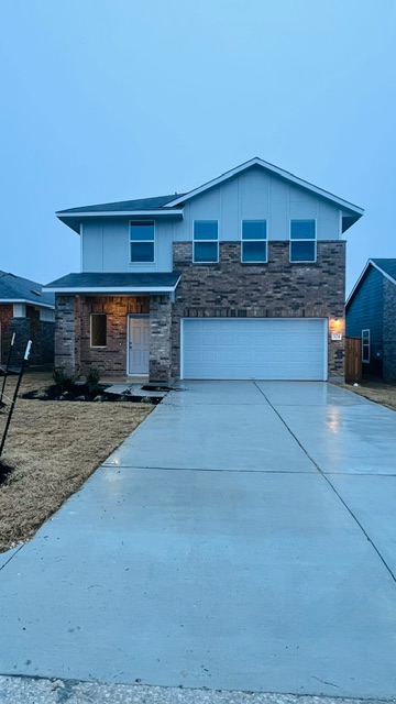 304 The Bad Way Jarrell, TX 76537 - Photo 5 of 26 a front view of a house with a yard and garage