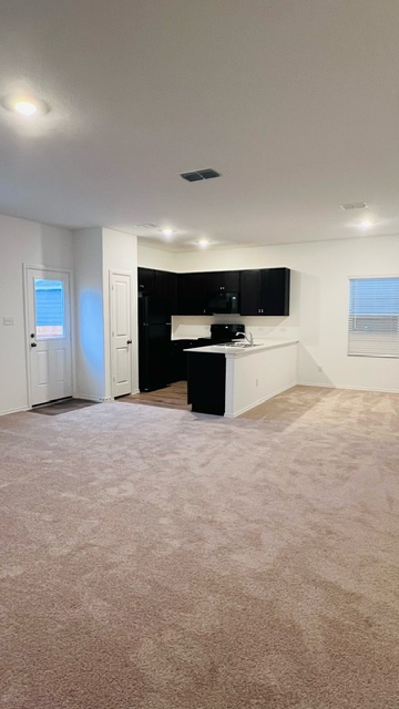 304 The Bad Way Jarrell, TX 76537 - Photo 25 of 26 a view of an empty room with a kitchen
