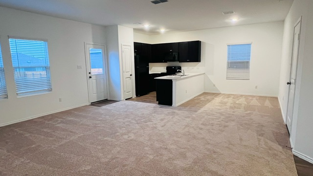 304 The Bad Way Jarrell, TX 76537 - Photo 26 of 26 a view of a kitchen with a sink and dishwasher a refrigerator with wooden floor