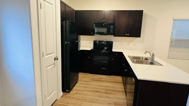 a view of an empty room with a kitchen