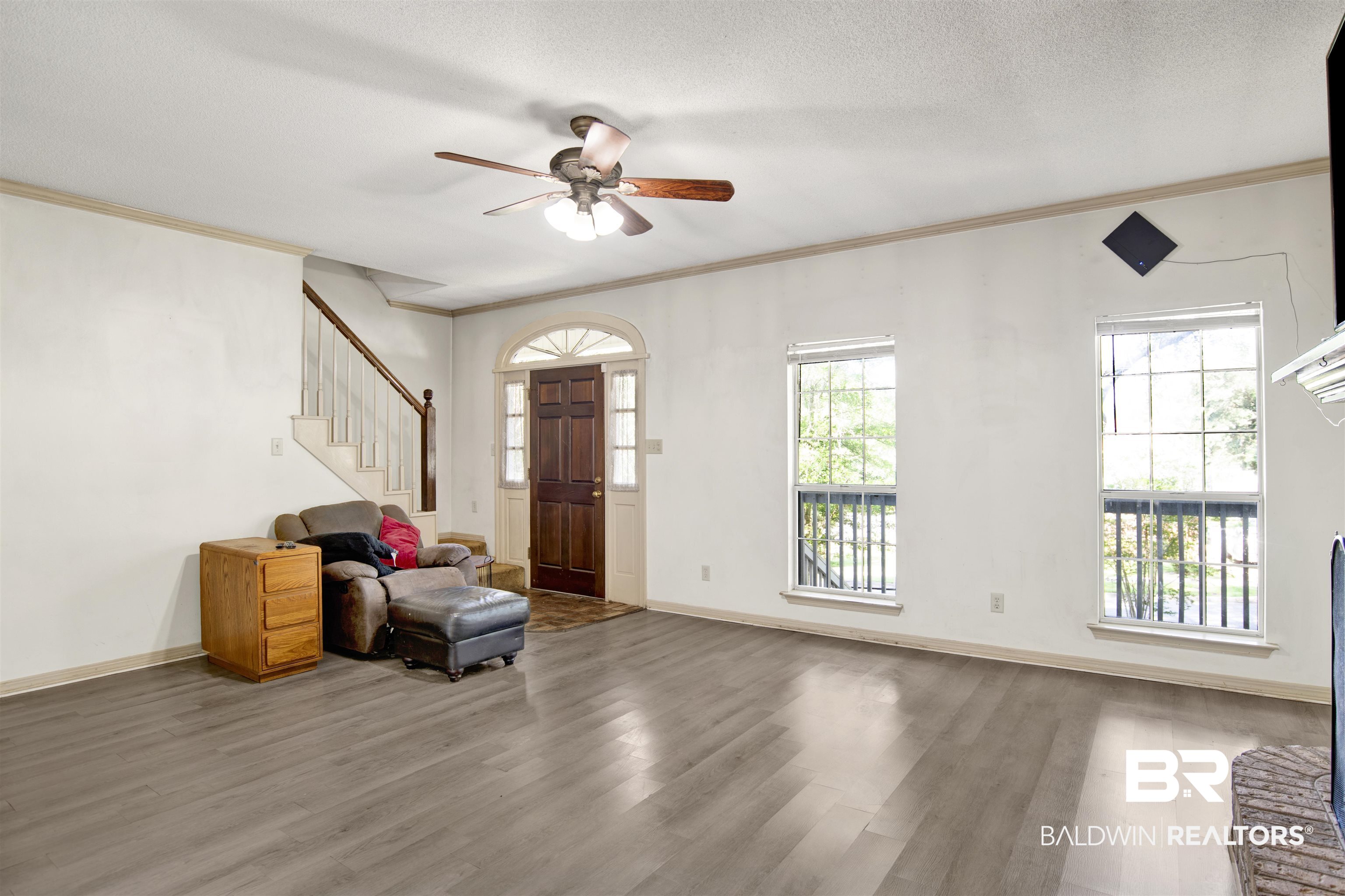 3412 Peyton Court Mobile, AL 36695 - Photo 7 of 27 Entrance foyer featuring wood finished floors, stairway, crown molding, a ceiling fan, and baseboards