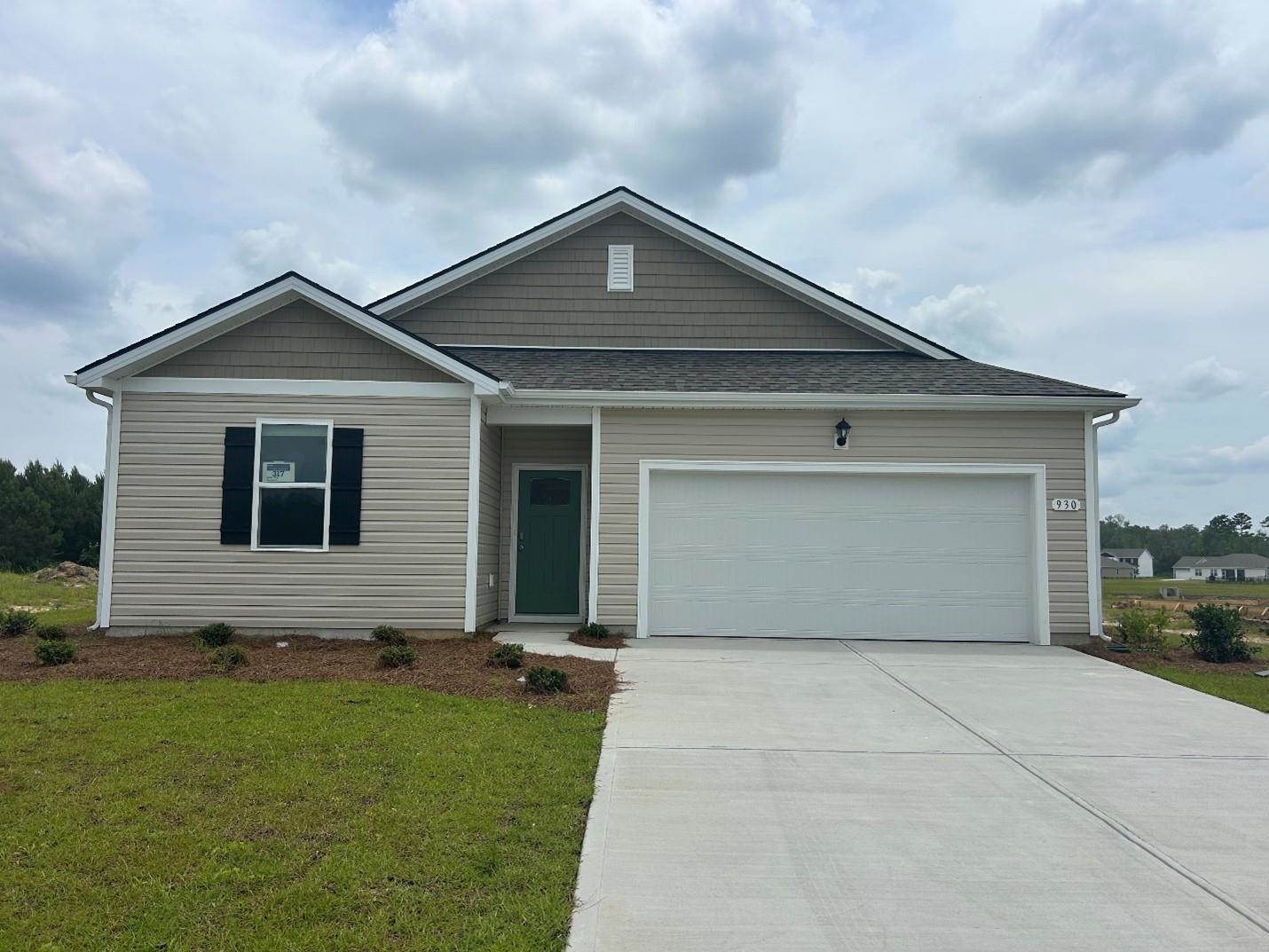 930 Farmers Psge Loop Loris, SC 29569 - Photo 1 of 19 View of front facade with an attached garage, driveway, a shingled roof, and a front lawn