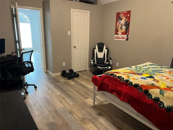 a room with gym equipment on wooden floor