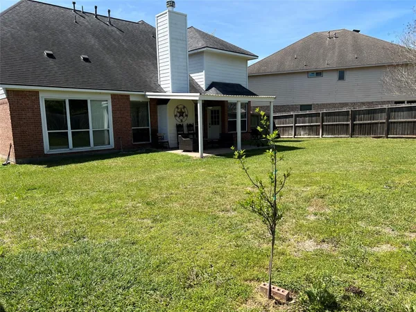 a view of a backyard with wooden fence
