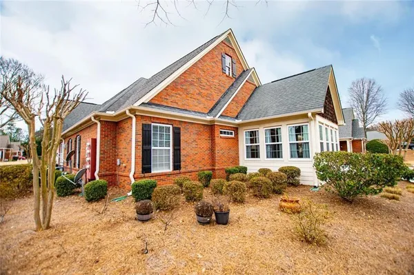 a view of a chairs and table in the back yard of the house