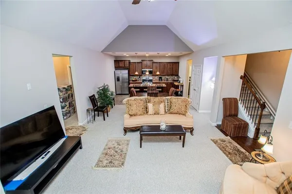 a kitchen with stainless steel appliances granite countertop a sink and a refrigerator