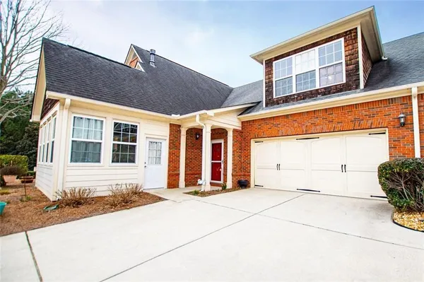a living room with furniture a chandelier and a dining room
