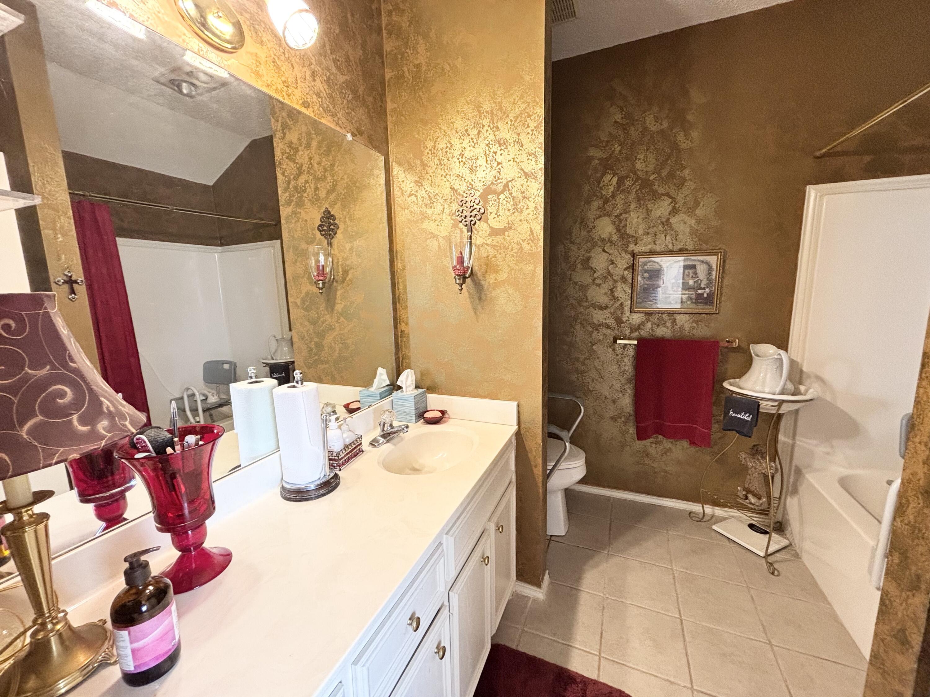 306 Ave M Abernathy, TX 79311 - Photo 12 of 22 a bathroom with a sink mirror and a toilet