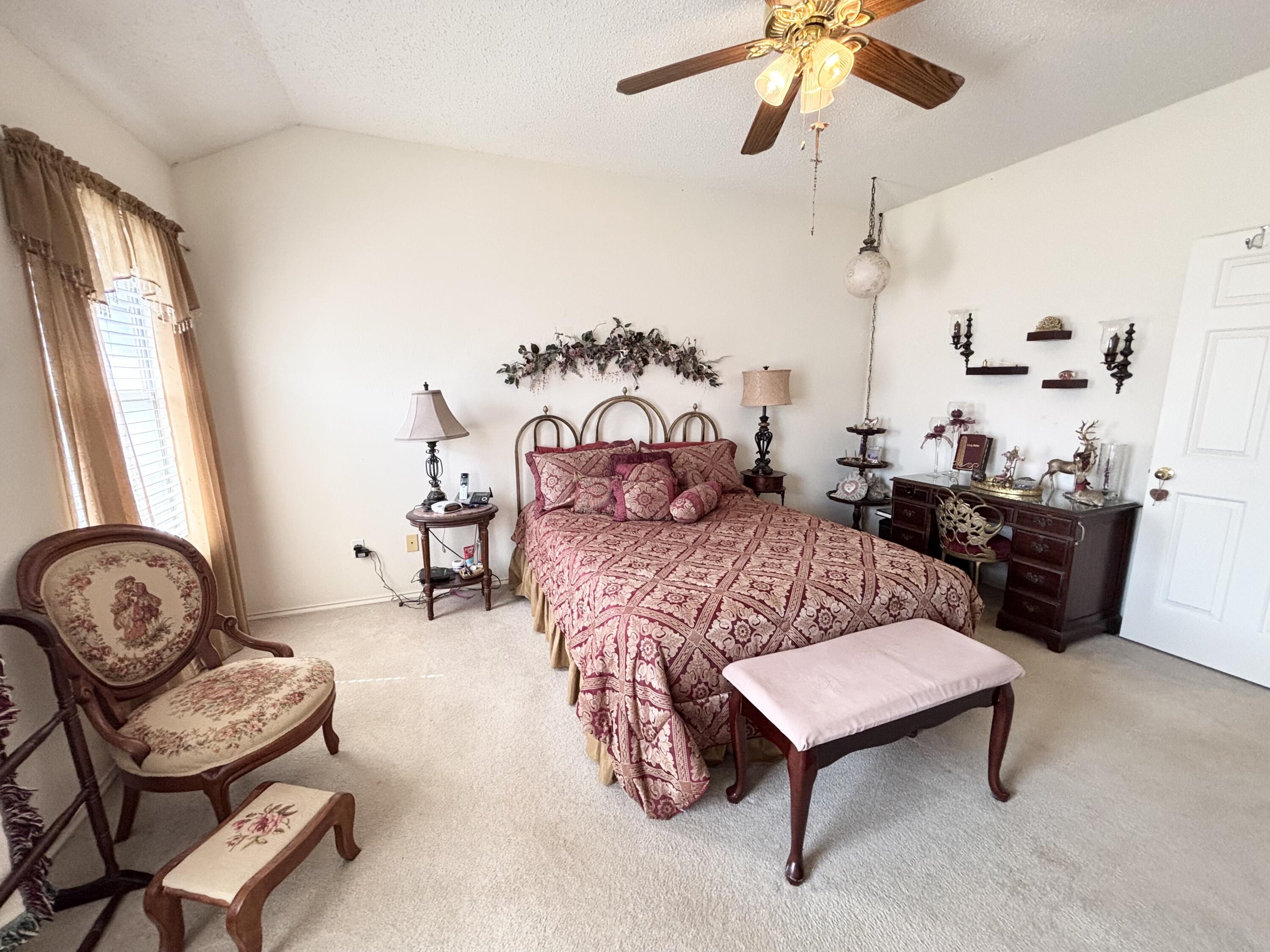 306 Ave M Abernathy, TX 79311 - Photo 13 of 22 a bedroom with a bed a chair and a chandelier