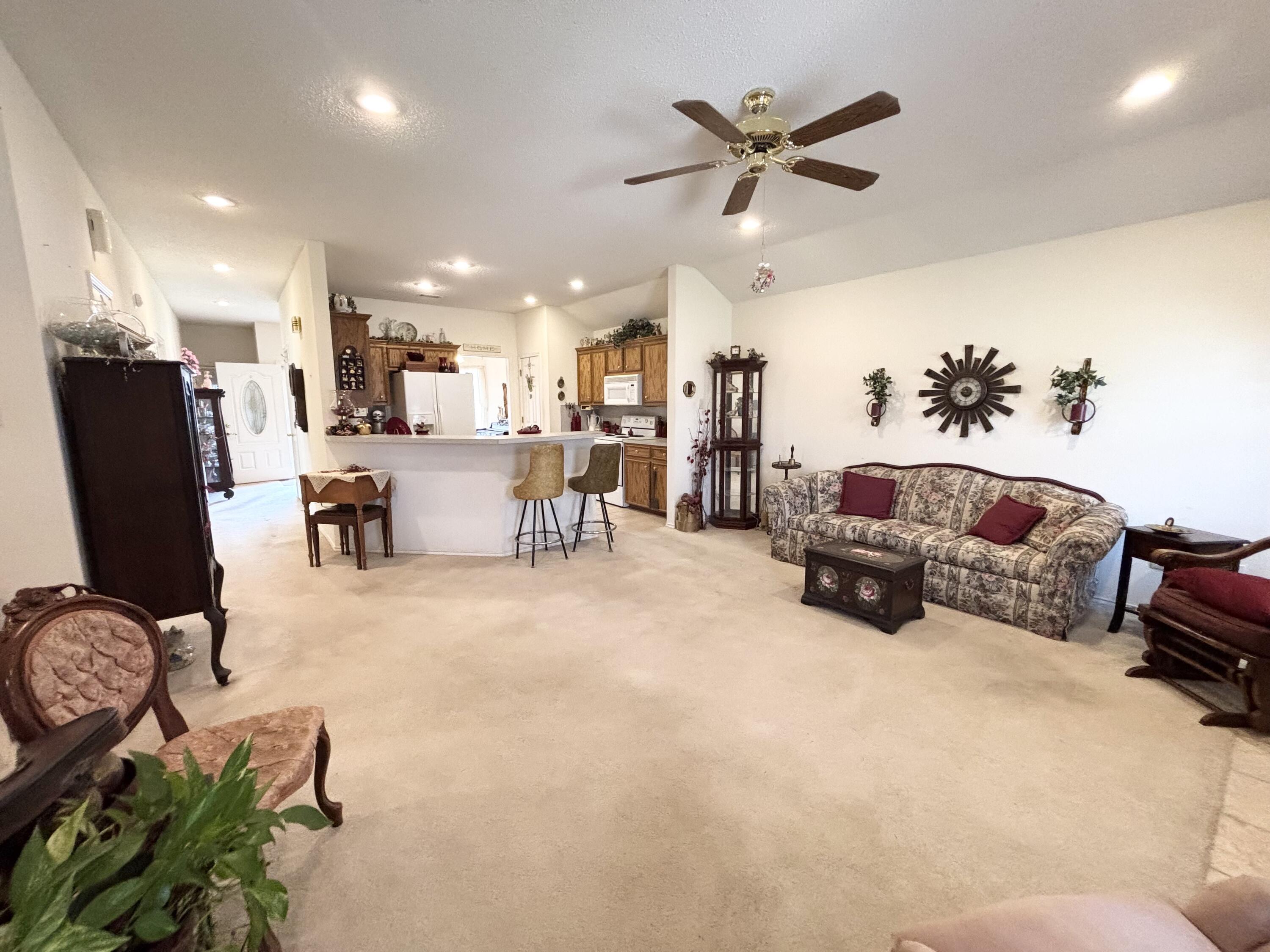 306 Ave M Abernathy, TX 79311 - Photo 14 of 22 a living room with furniture kitchen view and a chandelier