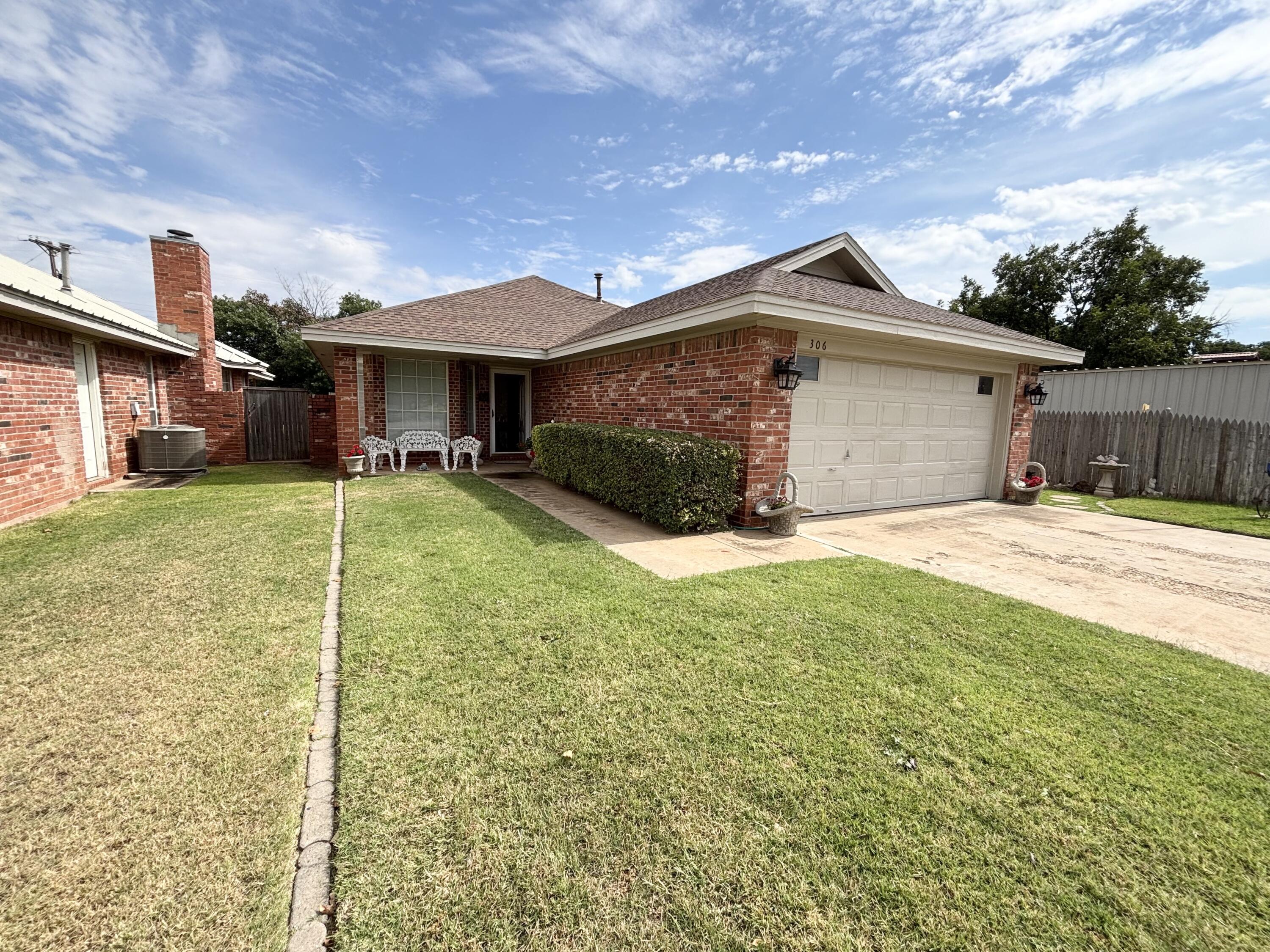 306 Ave M Abernathy, TX 79311 - Photo 3 of 22 a front view of a house with yard and garage