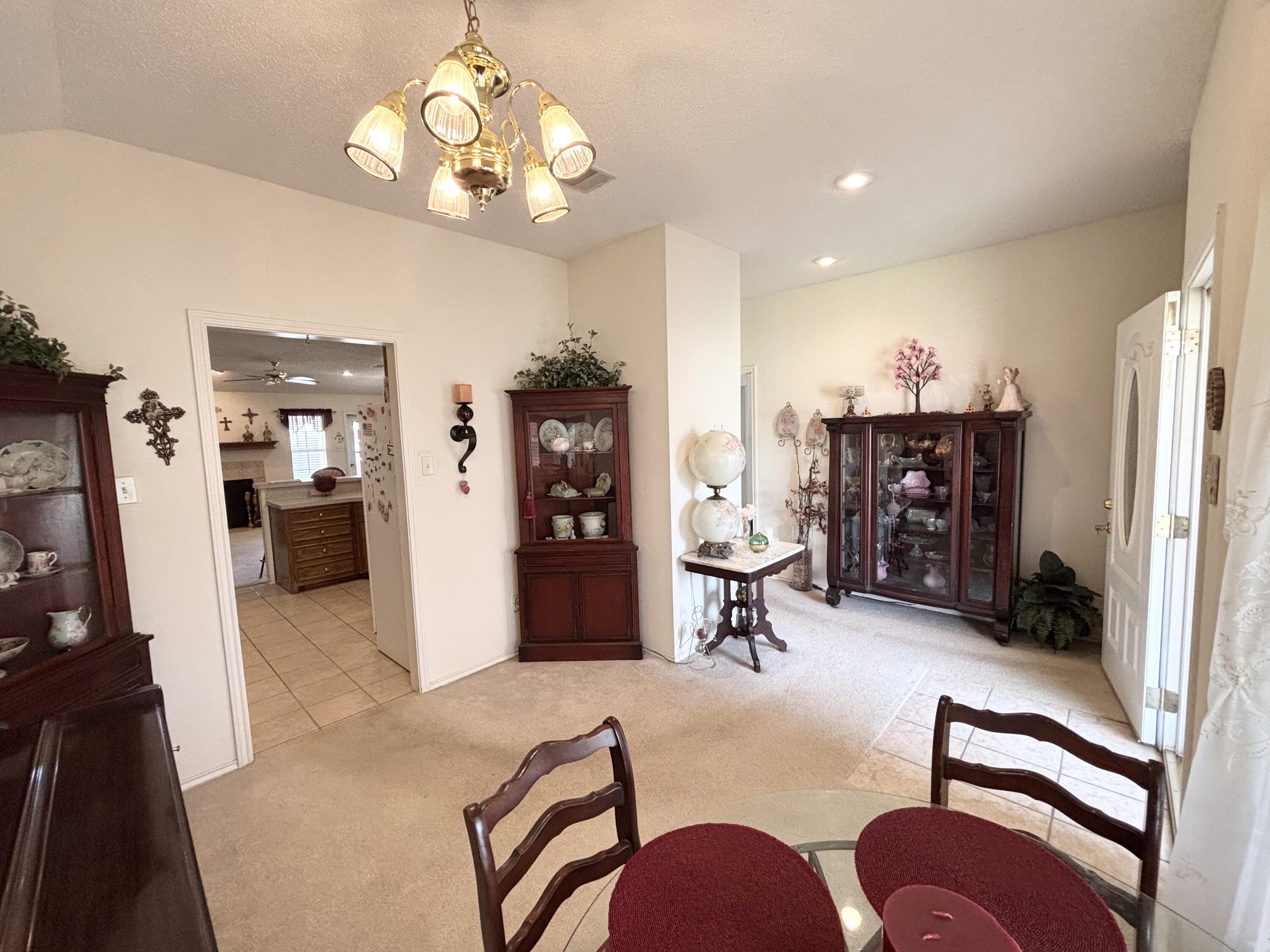 306 Ave M Abernathy, TX 79311 - Photo 6 of 22 a living room with furniture a dining table and a refrigerator