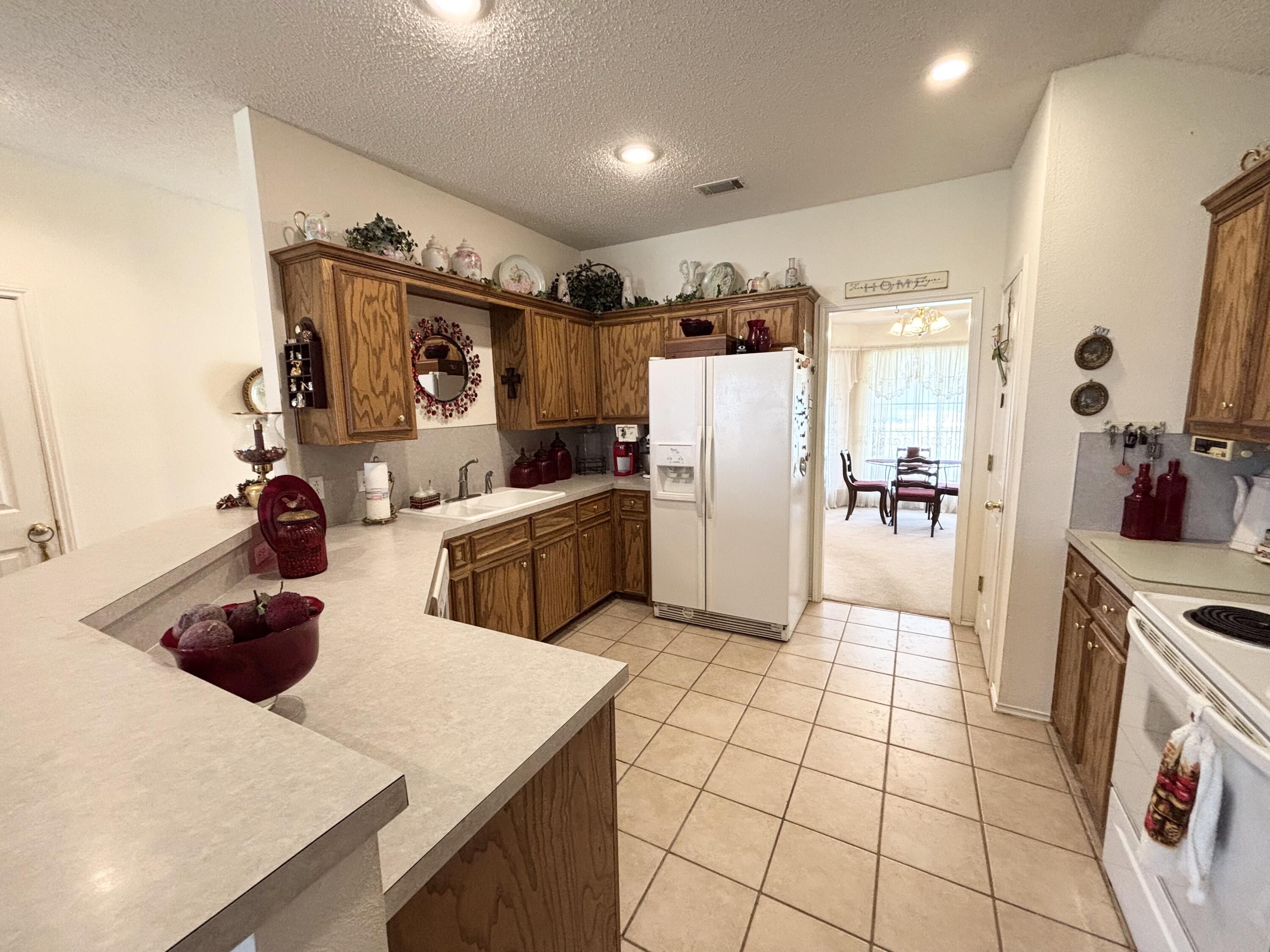 306 Ave M Abernathy, TX 79311 - Photo 7 of 22 a kitchen with stainless steel appliances a refrigerator sink and cabinets