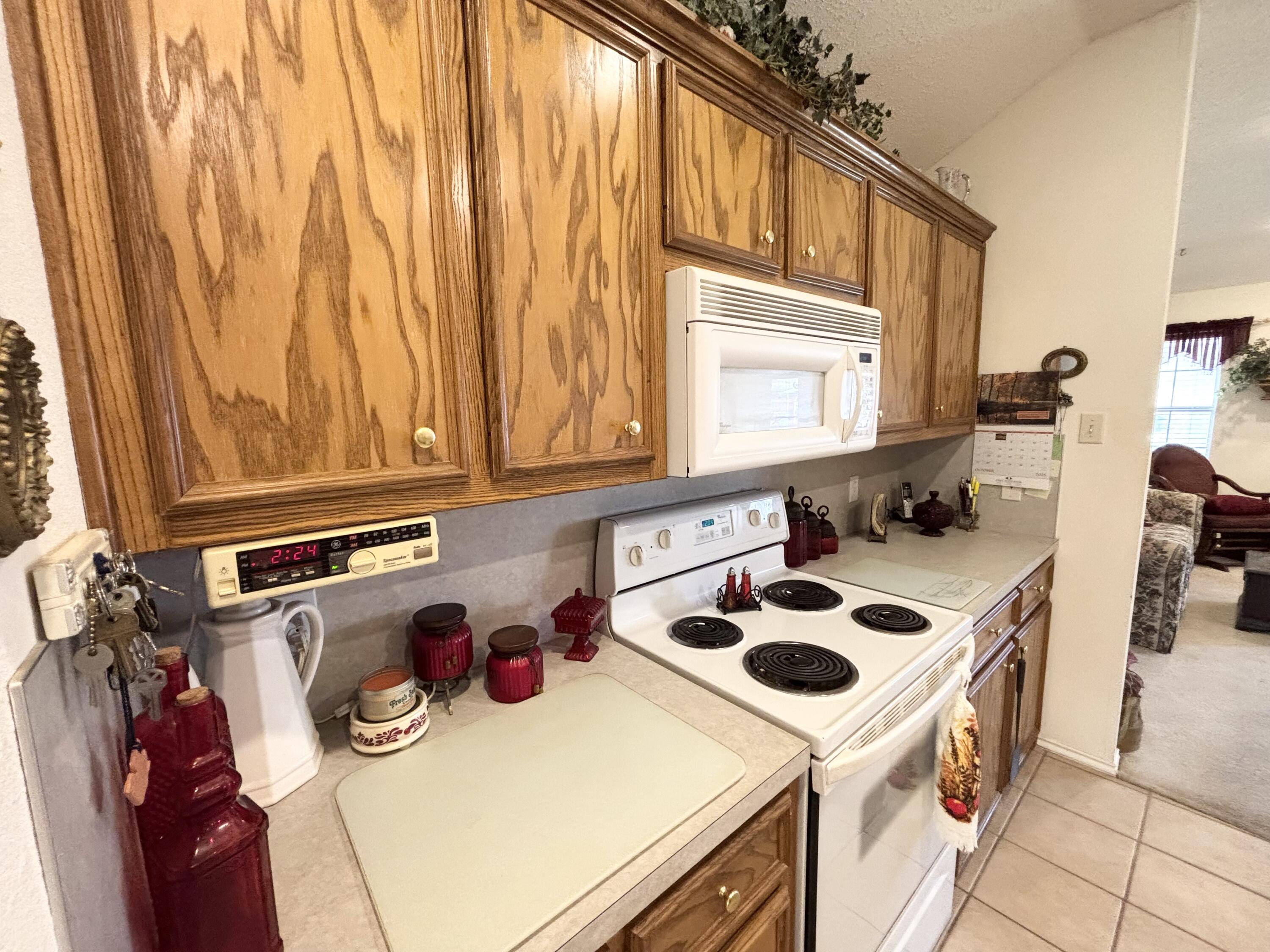 306 Ave M Abernathy, TX 79311 - Photo 9 of 22 a kitchen with a stove a sink and a microwave