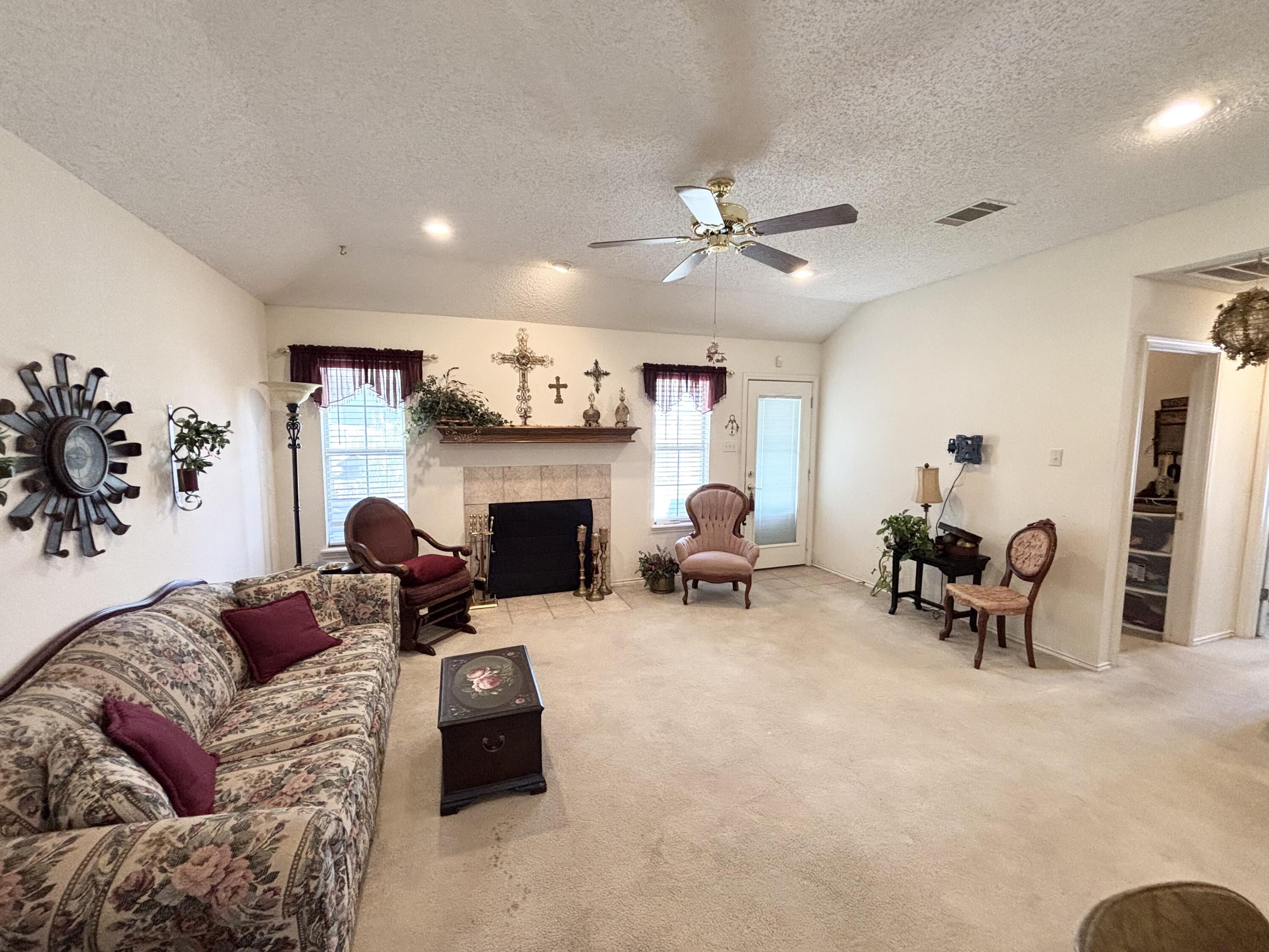 306 Ave M Abernathy, TX 79311 - Photo 10 of 22 a living room with furniture fireplace and a flat screen tv