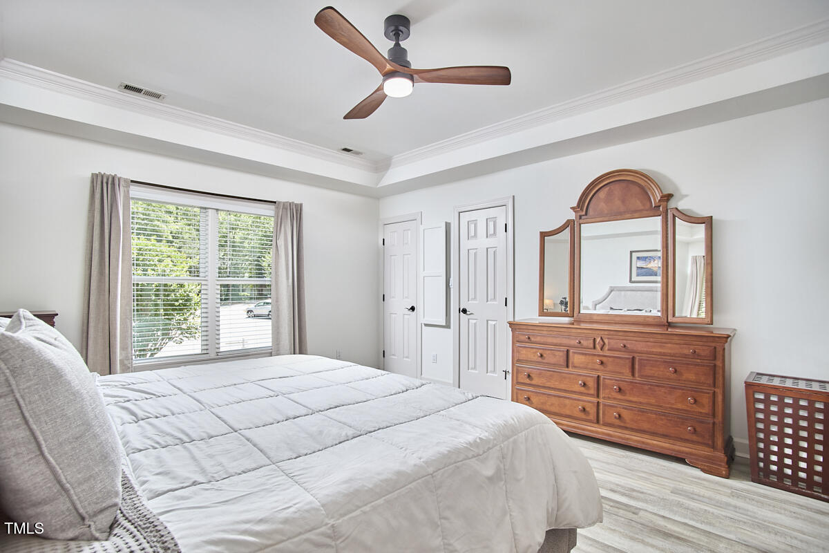 407 Crickentree Drive Cary, NC 27518 - Photo 42 of 78 a bedroom with a large bed and a large dresser