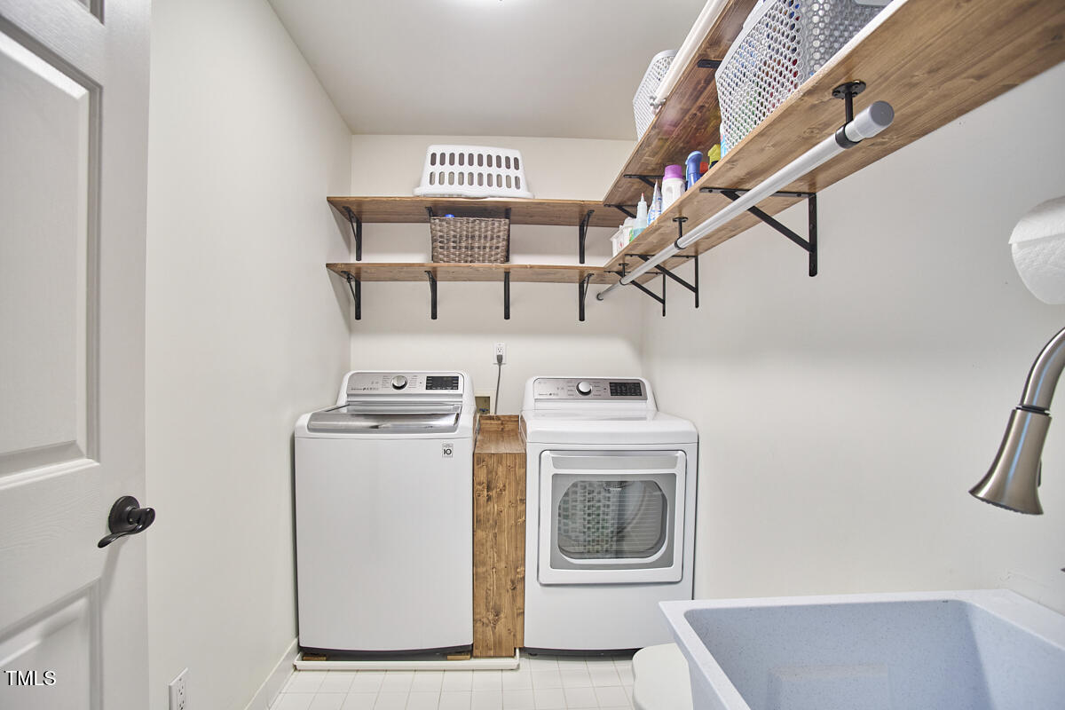 407 Crickentree Drive Cary, NC 27518 - Photo 56 of 78 a view of storage and utility room with washer and dryer