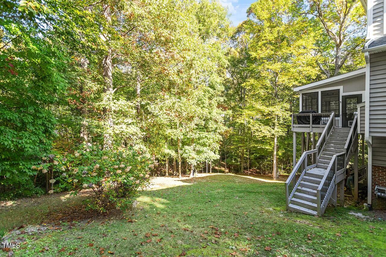 407 Crickentree Drive Cary, NC 27518 - Photo 73 of 78 a backyard of a house with lots of plants and entertaining space