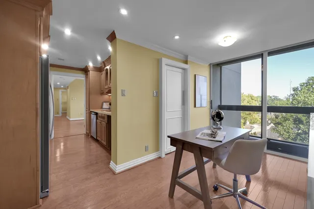 a view of a dining room with furniture large window and wooden floor