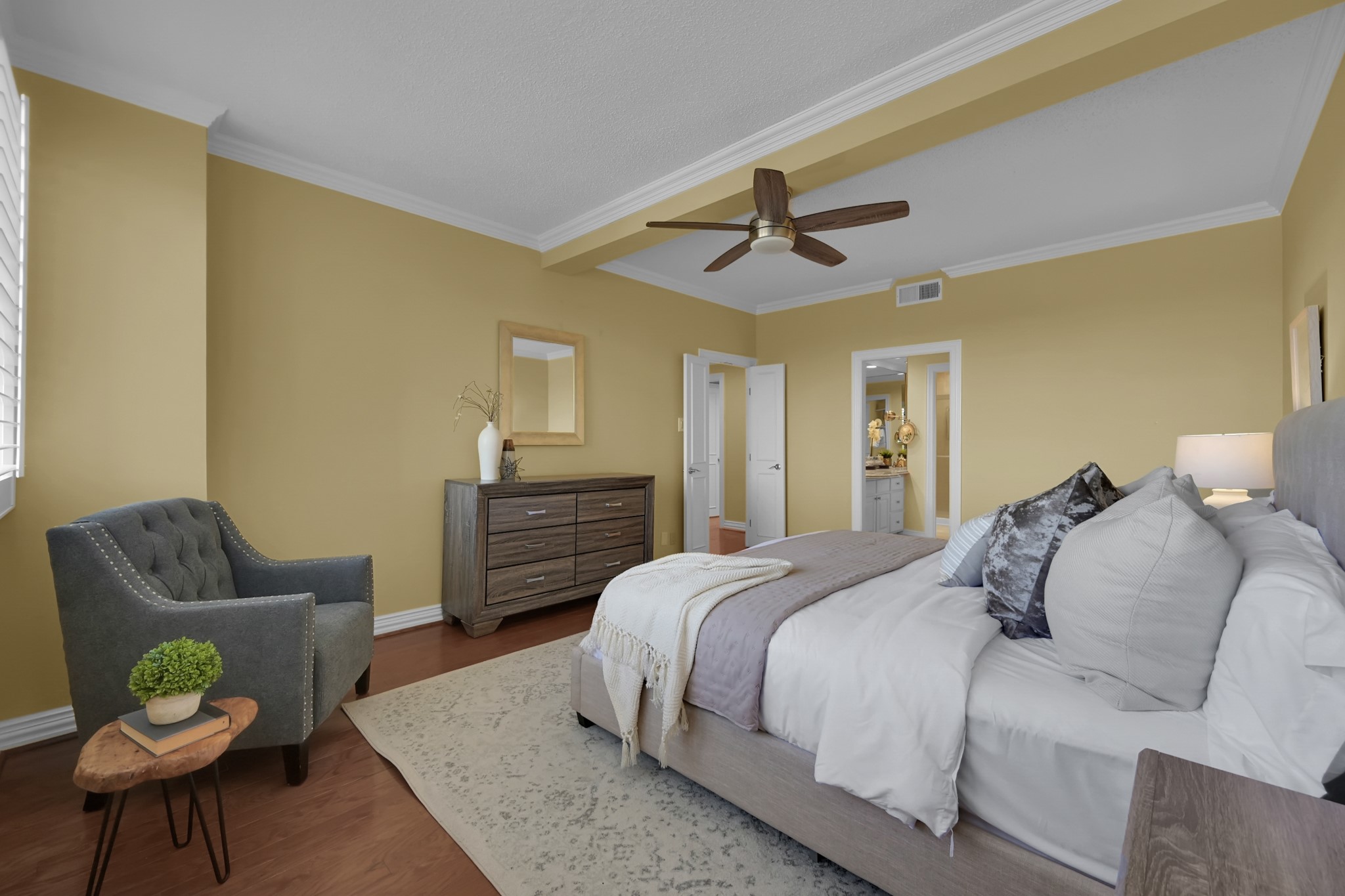 49 Briar Hollow Lane, Unit 504 Houston, TX 77027 - Photo 17 of 25 a spacious bedroom with a bed a couch and chair