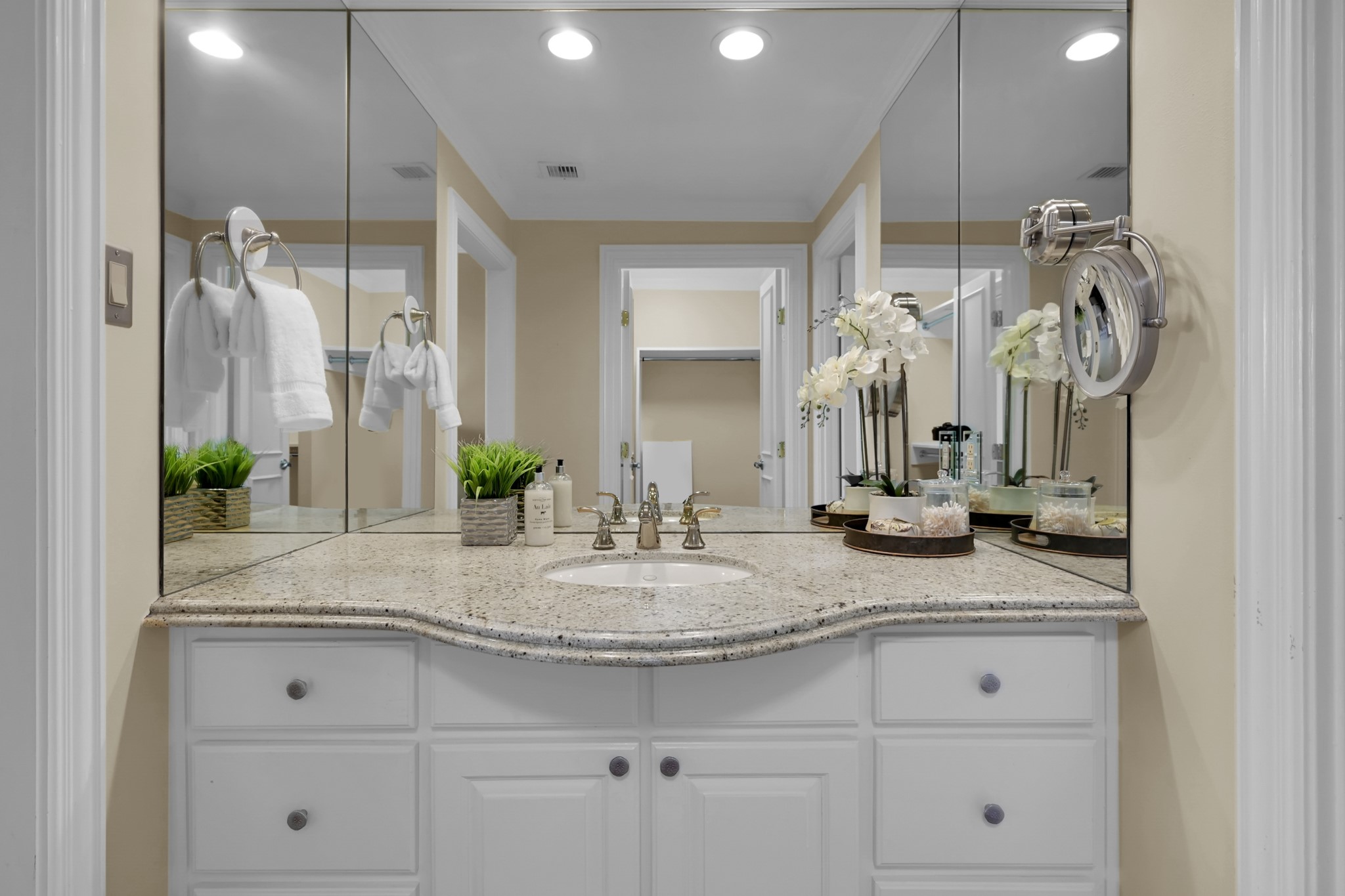 49 Briar Hollow Lane, Unit 504 Houston, TX 77027 - Photo 18 of 25 a bathroom with double vanity sink and a mirror