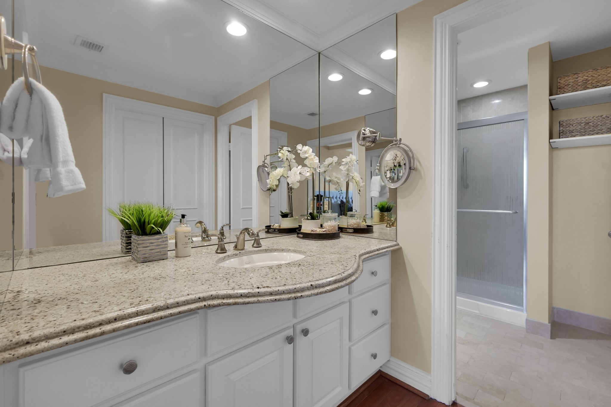 49 Briar Hollow Lane, Unit 504 Houston, TX 77027 - Photo 19 of 25 a bathroom with a granite countertop sink a potted plant and a shower