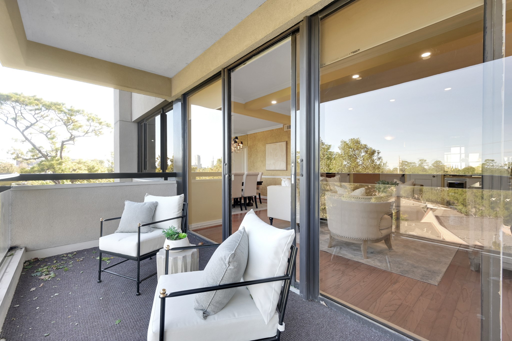 49 Briar Hollow Lane, Unit 504 Houston, TX 77027 - Photo 3 of 25 a living room with patio furniture and a floor to ceiling window