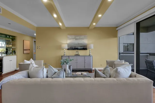 a living room with furniture and kitchen view