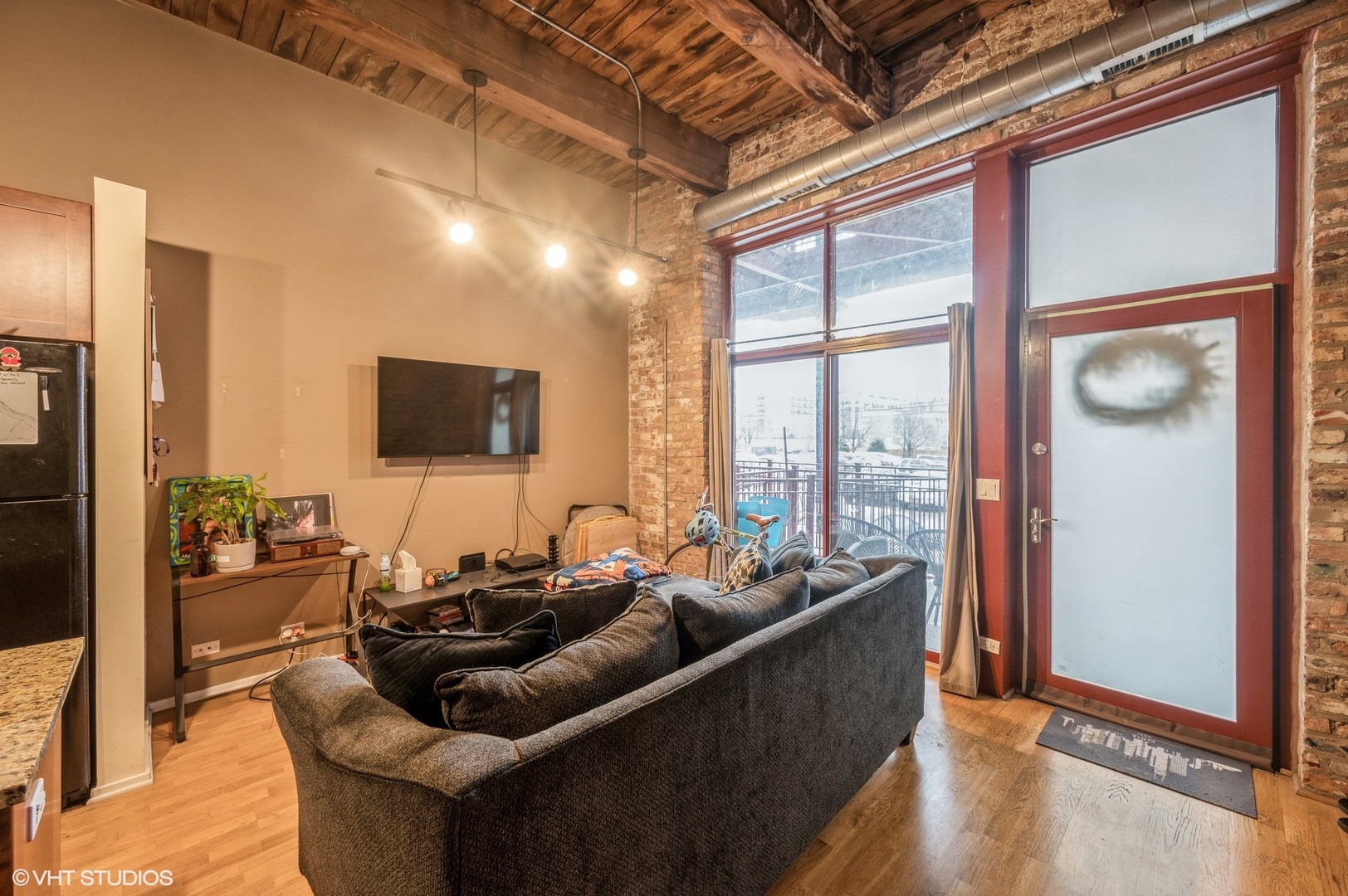 1061 West 16th Street, Unit 201 Chicago, IL 60608 - Photo 2 of 14 a living room with furniture and a flat screen tv
