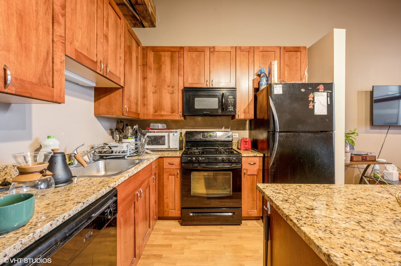 1061 West 16th Street, Unit 201 Chicago, IL 60608 - Photo 4 of 14 a kitchen with stainless steel appliances granite countertop a sink stove and refrigerator