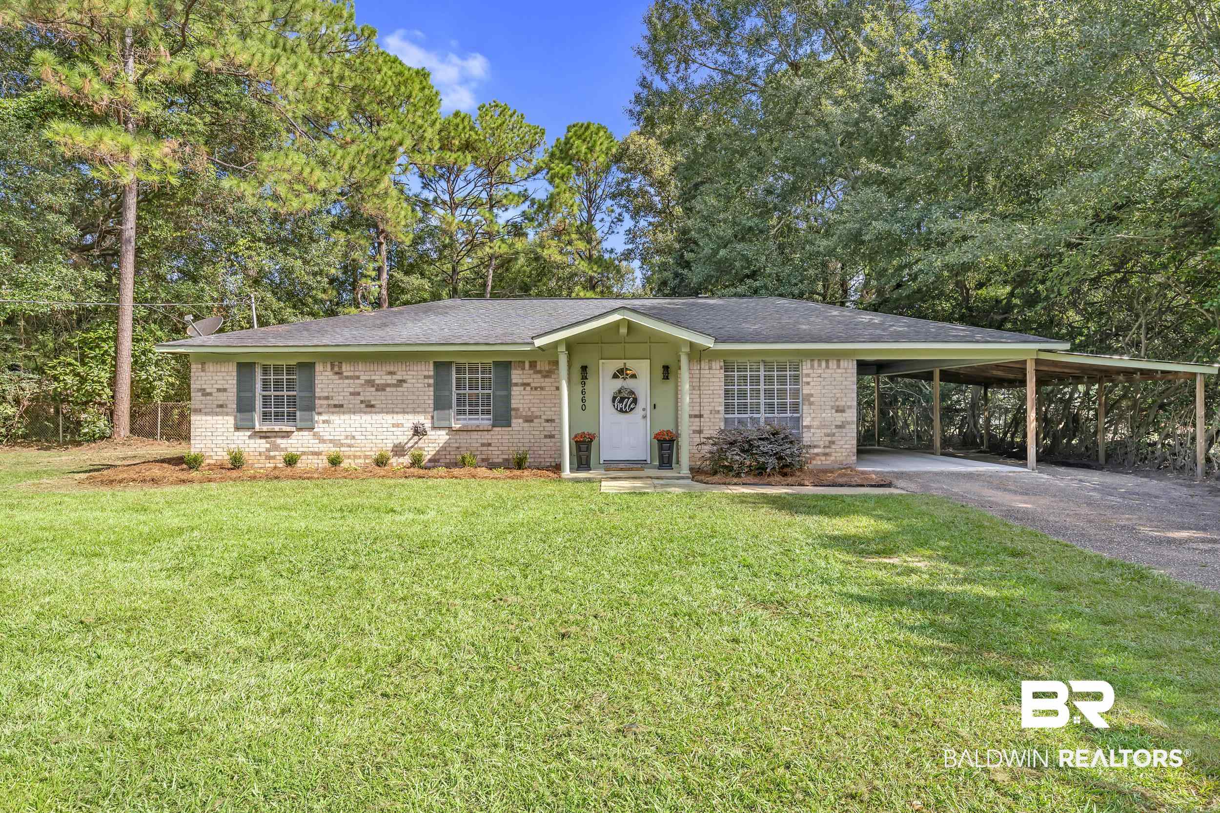 9660 Howells Ferry Road Semmes, AL 36575 - Photo 2 of 23 Ranch-style house with an attached carport, driveway, a front yard, and brick siding