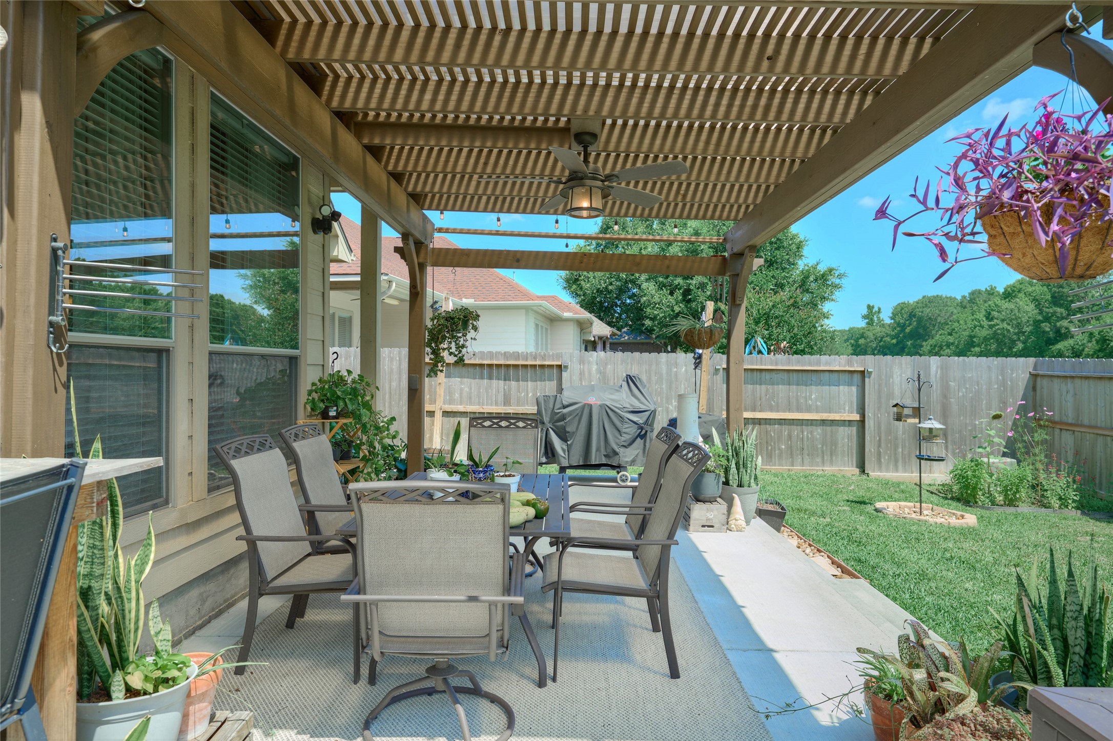 28322 Madelin Manor Lane Spring, TX 77386 - Photo 39 of 46 a view of a patio with table and chairs potted plants with wooden floor and fence