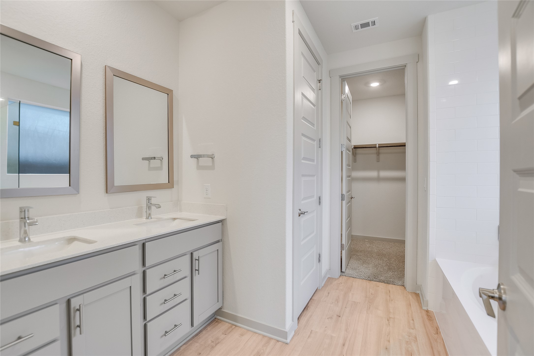 2244 Alamar Walk Leander, TX 78641 - Photo 7 of 22 a bathroom with a shower sink and mirror