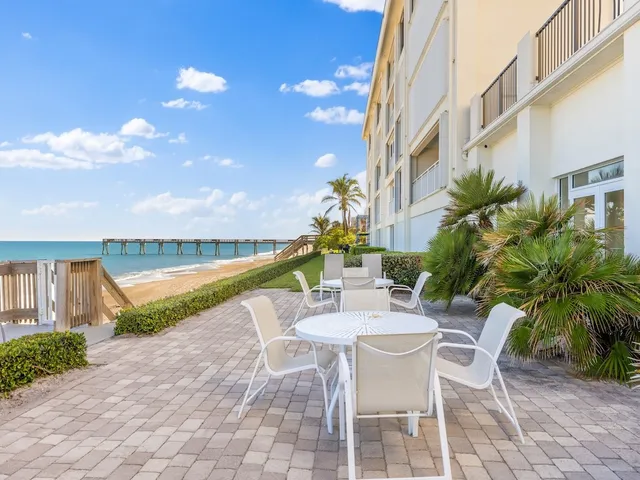 a view of a chair and tables in the patio
