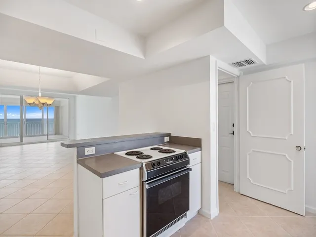 a kitchen that has a stove and a microwave oven