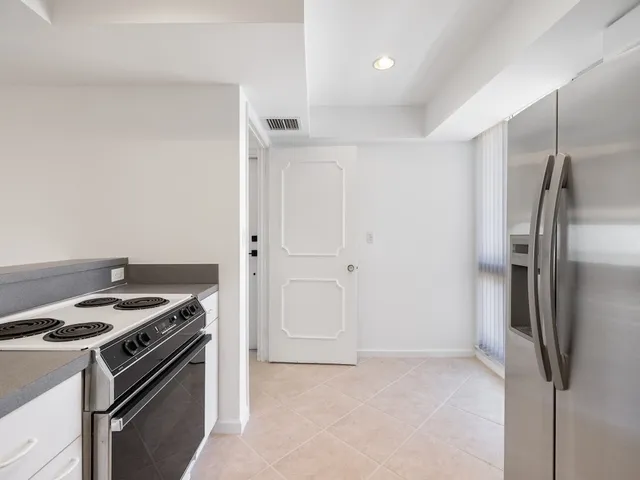 a kitchen with a stove and a refrigerator