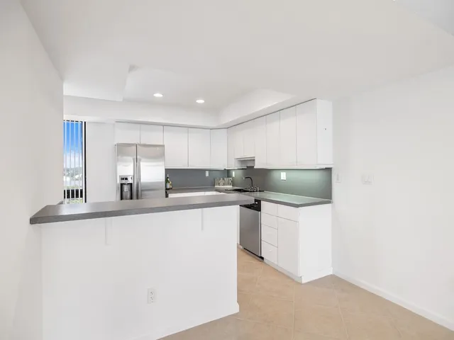 a kitchen with stainless steel appliances a sink and a refrigerator