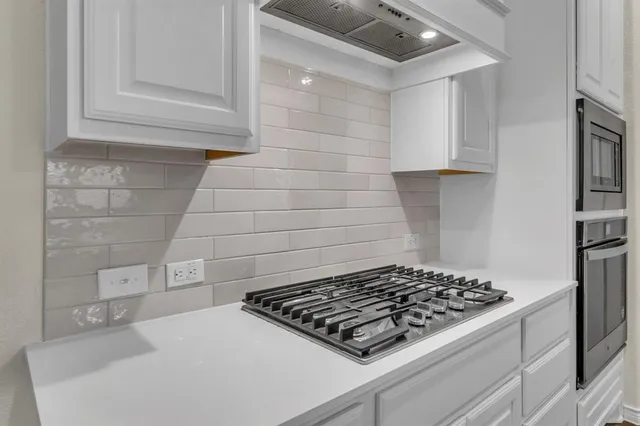 a stove top oven sitting inside of a kitchen