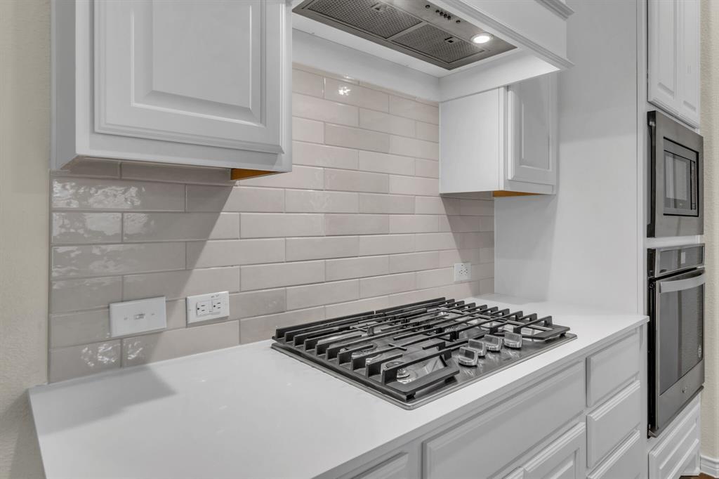 3106 Maverick Drive Forney, TX 75126 - Photo 11 of 29 a stove top oven sitting inside of a kitchen